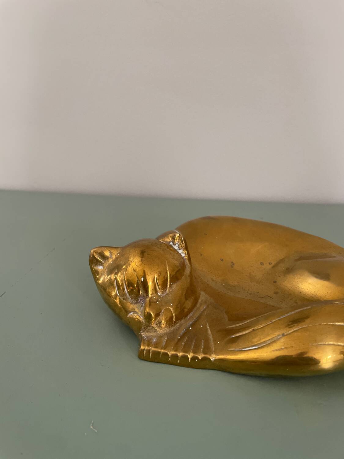 Cat-shaped catchall that looks like it's sleeping.