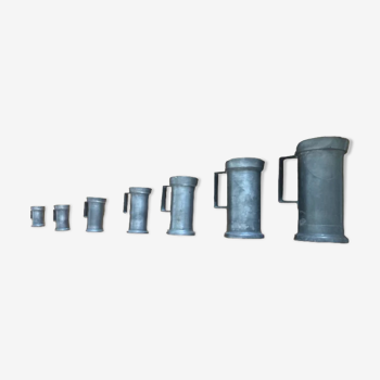 Set of 7 pots of tin measures
