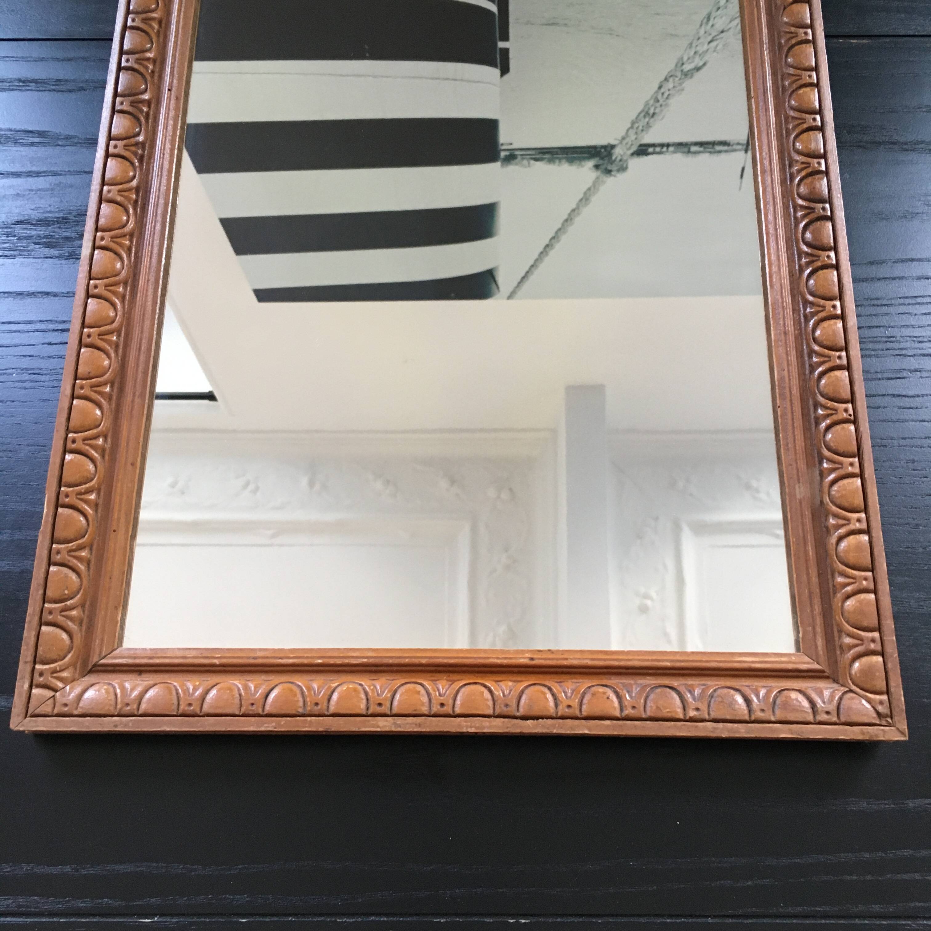 Antique mirror in ornate wood