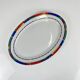 Oval porcelain plate by Van Well, multicoloured geometric border, 1980.