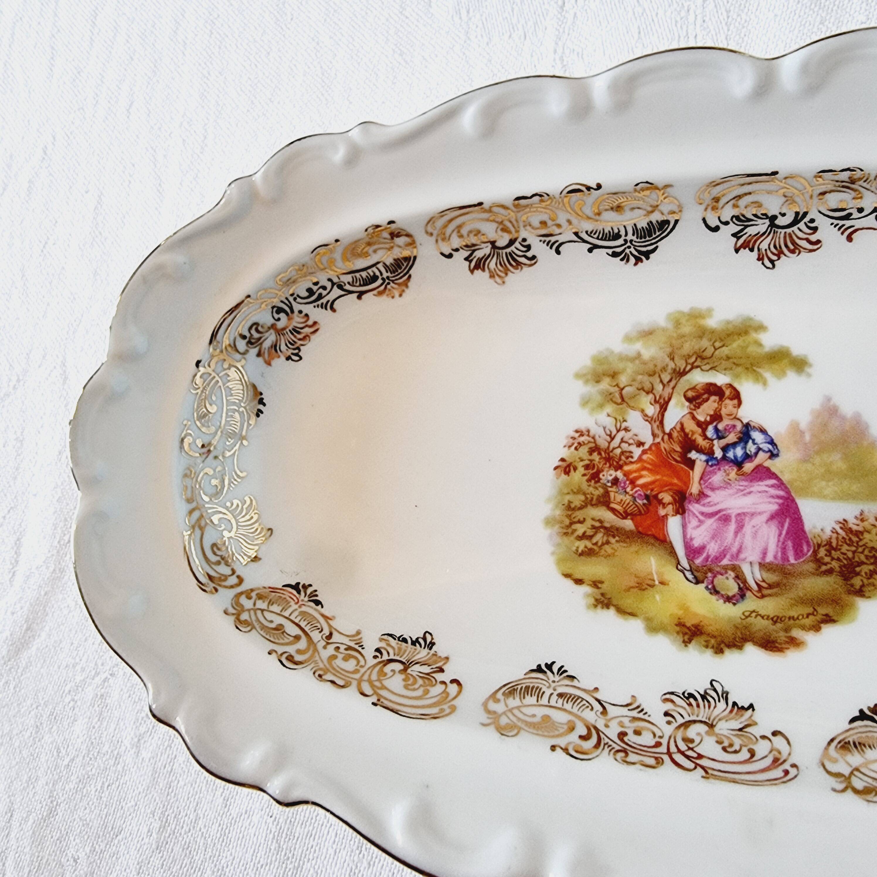 3 serving dishes with frangonard romantic scene with designs and borders in 24 carat gold.