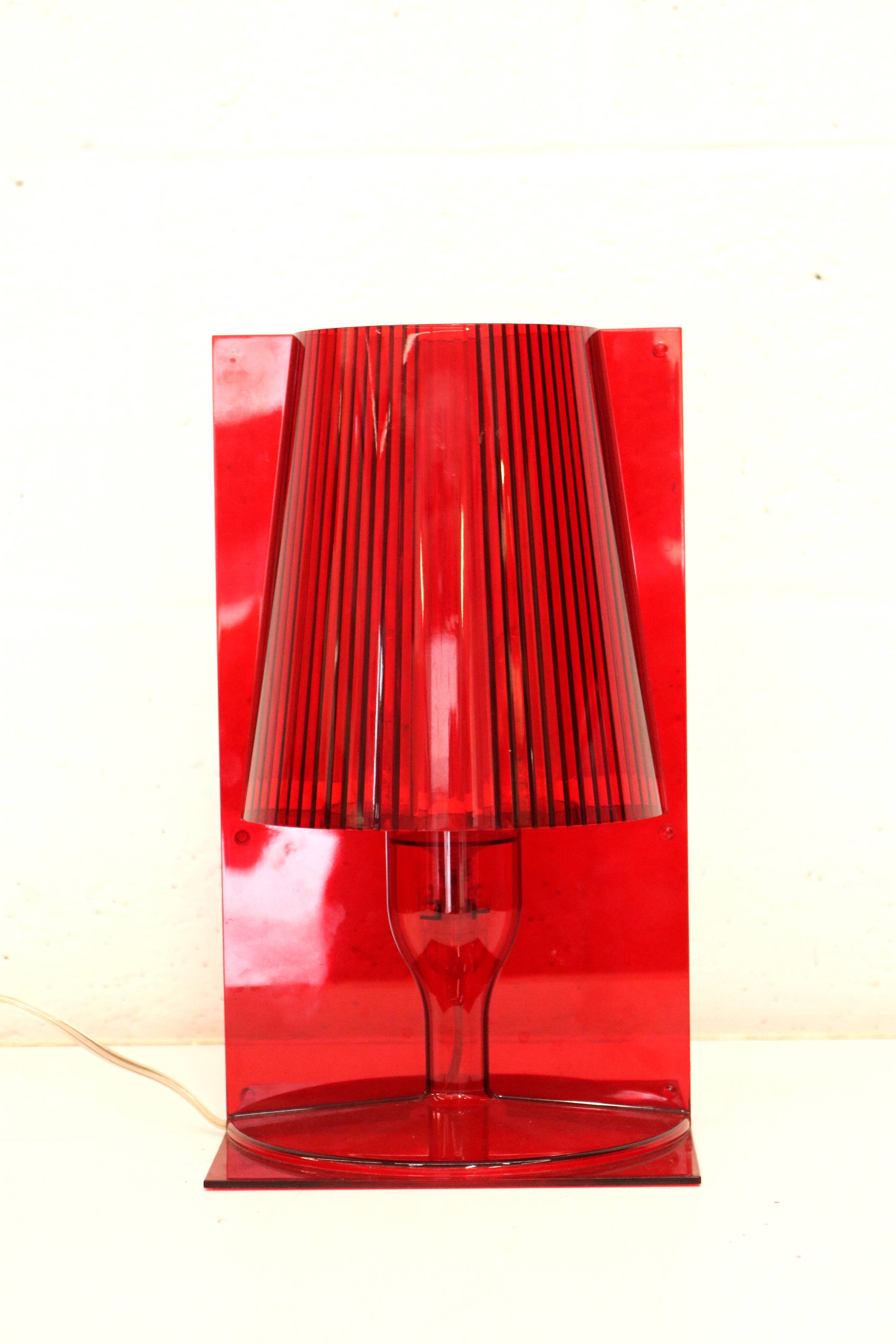 Red plastic Kartell table lamp - model Take - design by Ferruccio Laviani