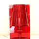 Red plastic Kartell table lamp - model Take - design by Ferruccio Laviani