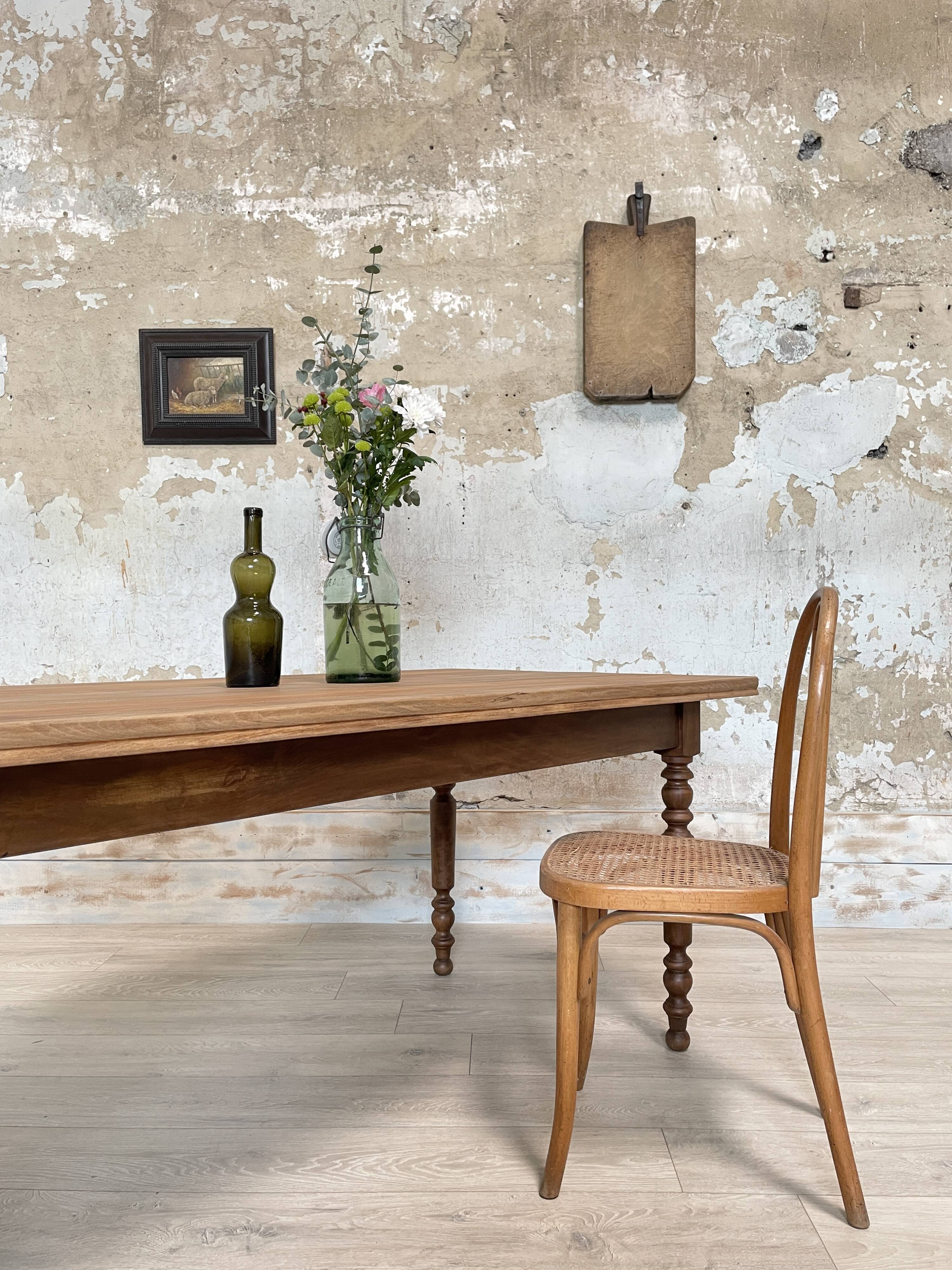 Vintage farmhouse table with turned legs.