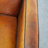 Sheep leather and wooden Art Deco design armchair with ball feet