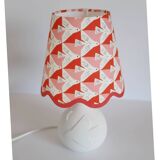 Small lamp with matte finish ceramic base and printed scalloped lampshade