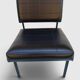 Modernist armchair in black faux leather and metal – 1960s