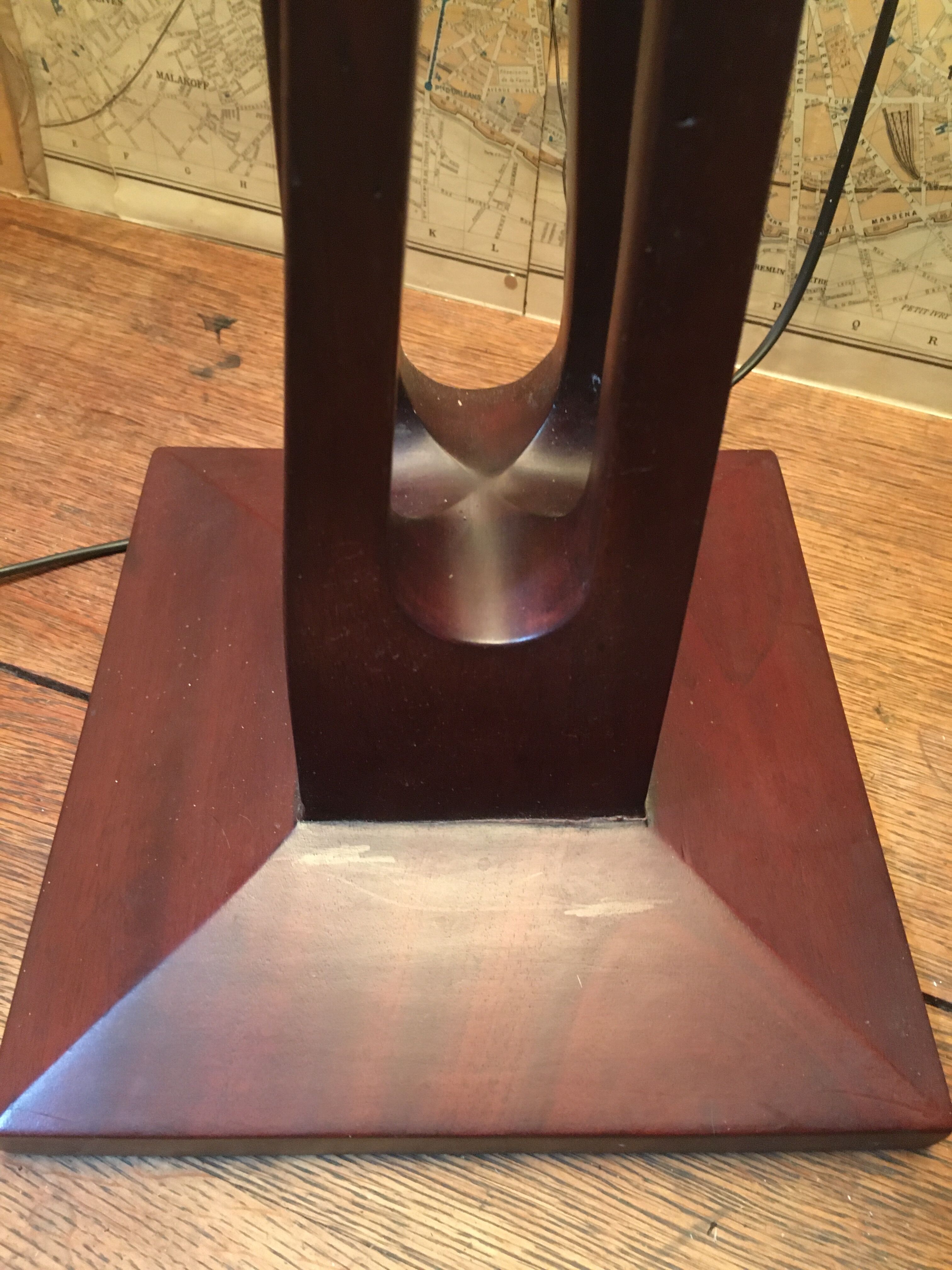Mahogany lamp with a sculpted base.