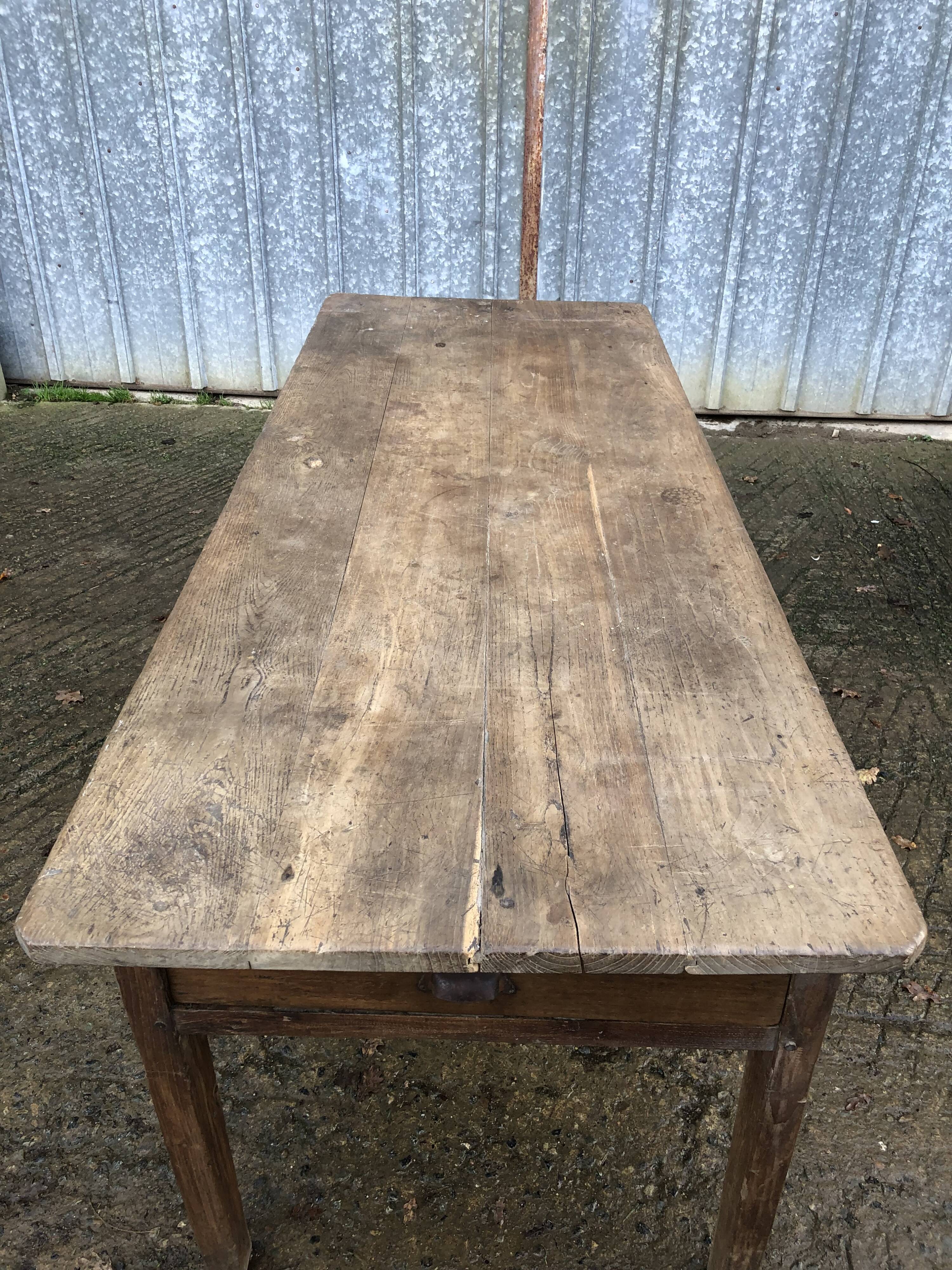 Antique farmhouse table in solid oak with tapered legs and 1 drawer at the end.