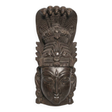 Ancient Indian carved wooden mask sculpture of a deity with a cobra.