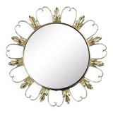 Round mirror on brass frame with scrolls