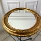 Grand miroir oval en stuc doré vintage
