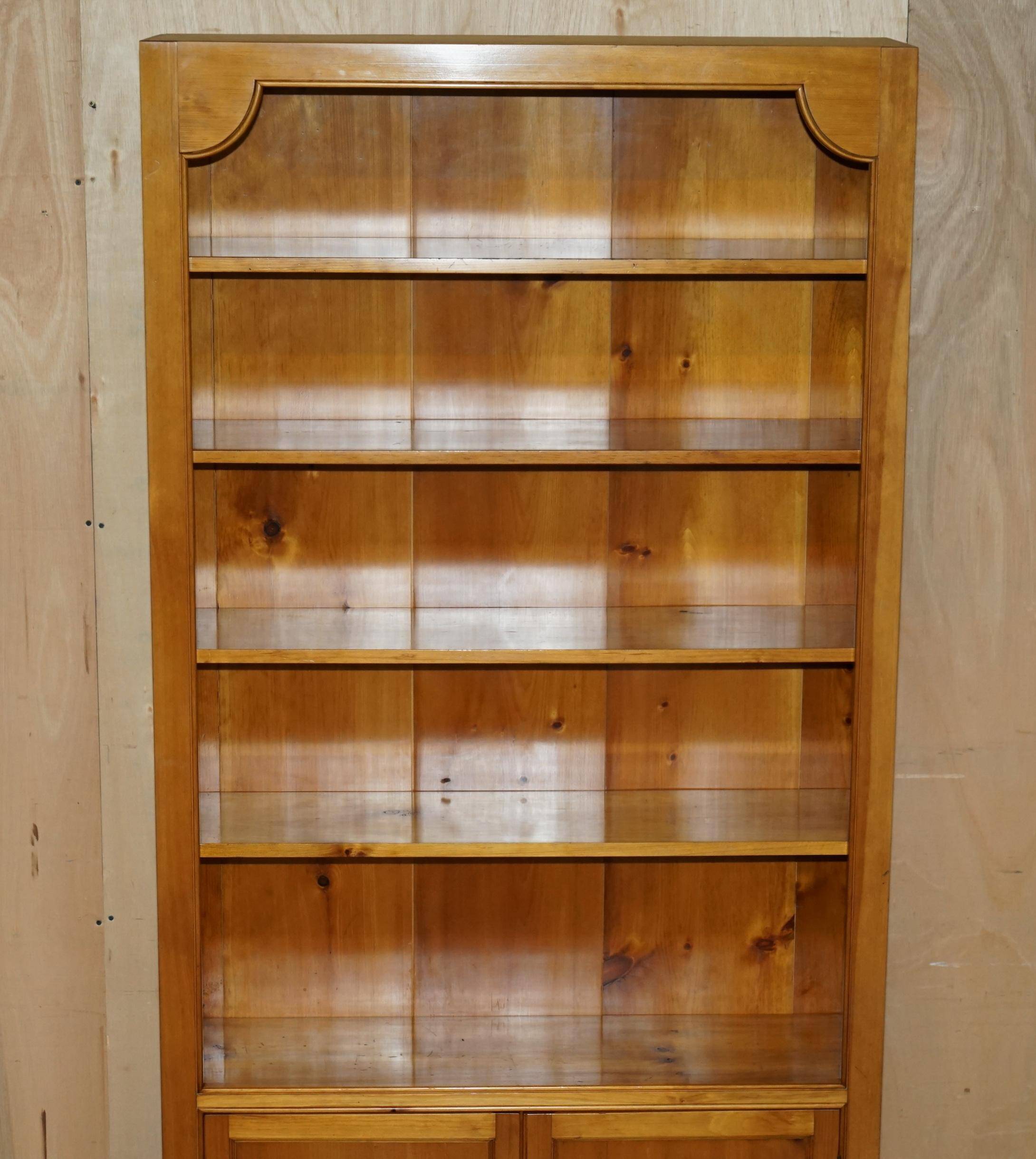 Pair of vintage cherry wood bookcases with lockable doors.