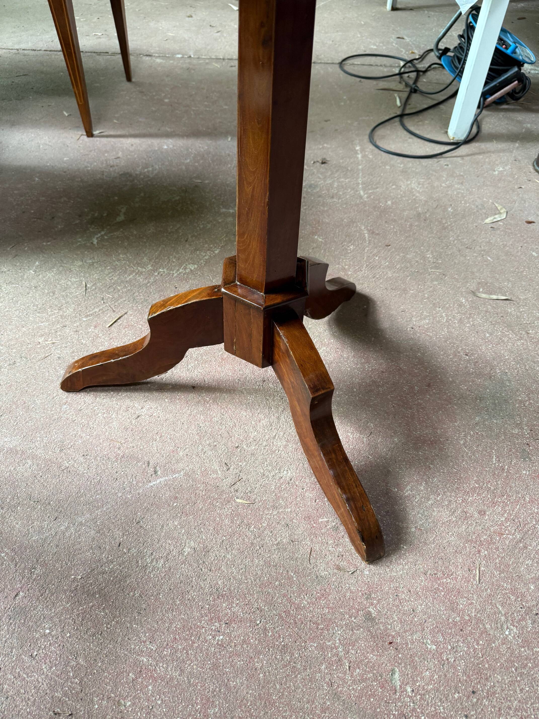 Antique round table with floral details.