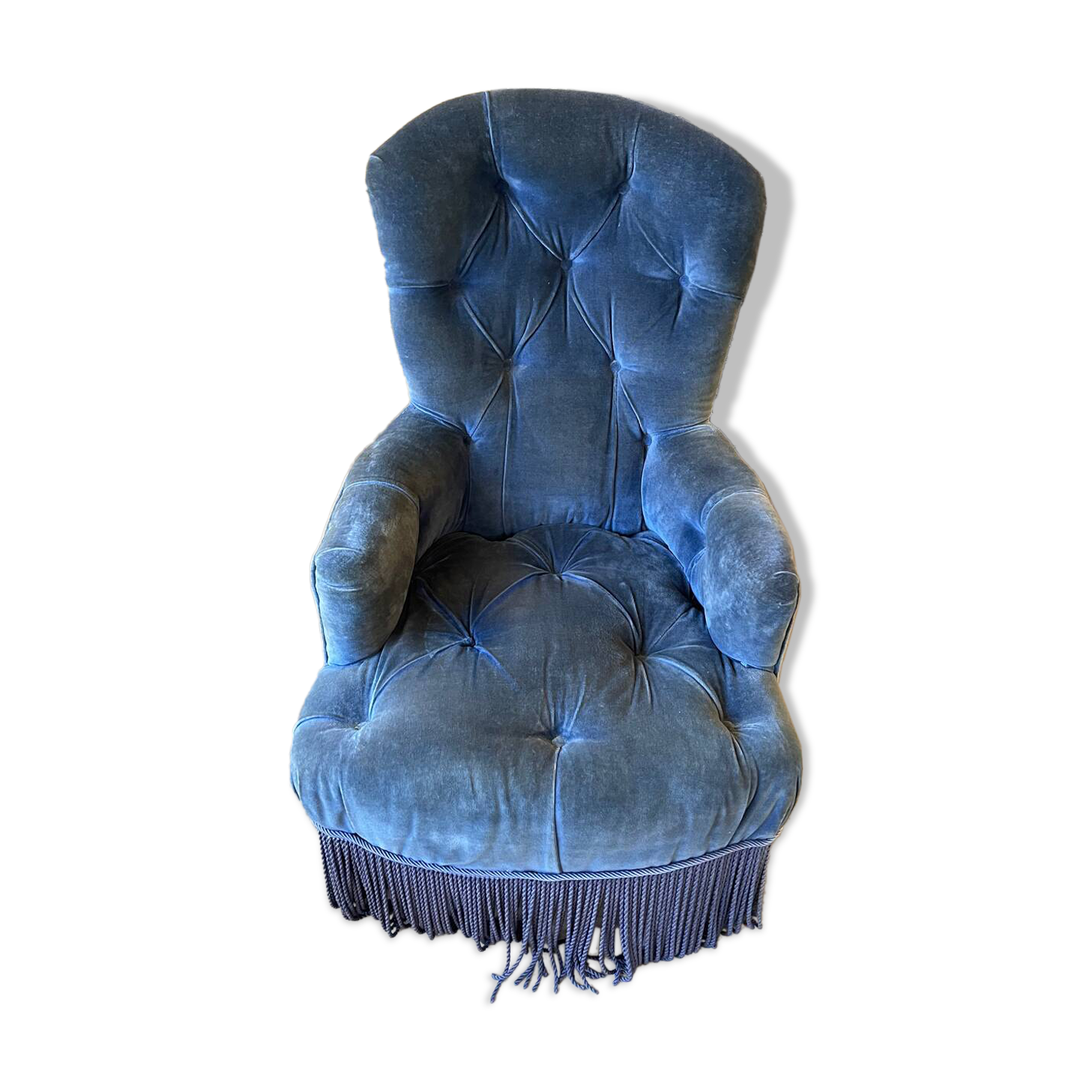 Fauteuil capitonné en velours bleu
