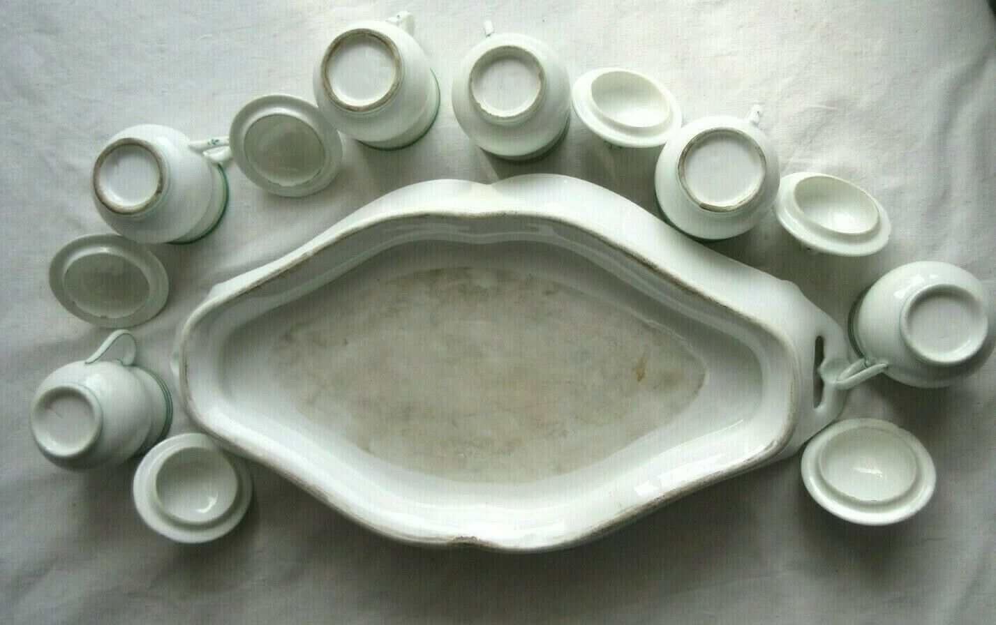 Porcelain cream service of Paris 1850, 6 pots on green and gold oval tray