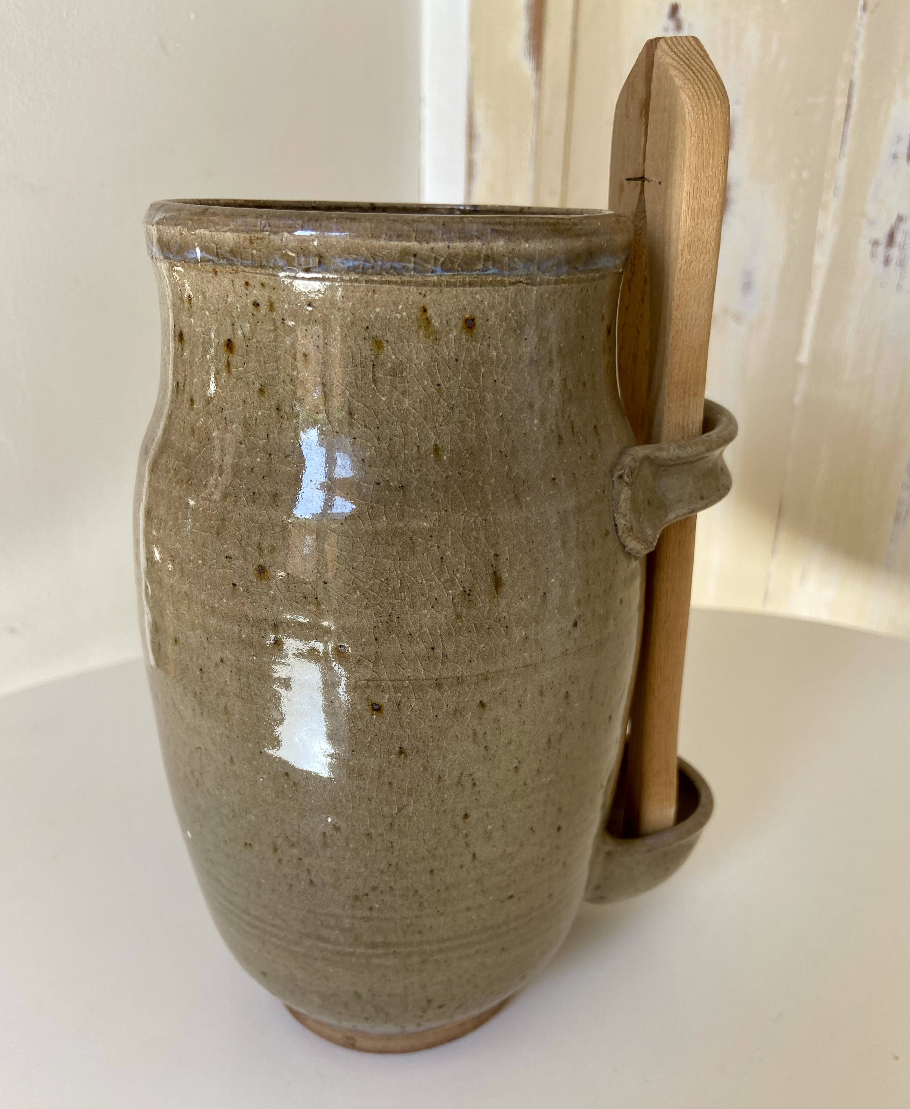 Old varnished stoneware pickle pot with tongs