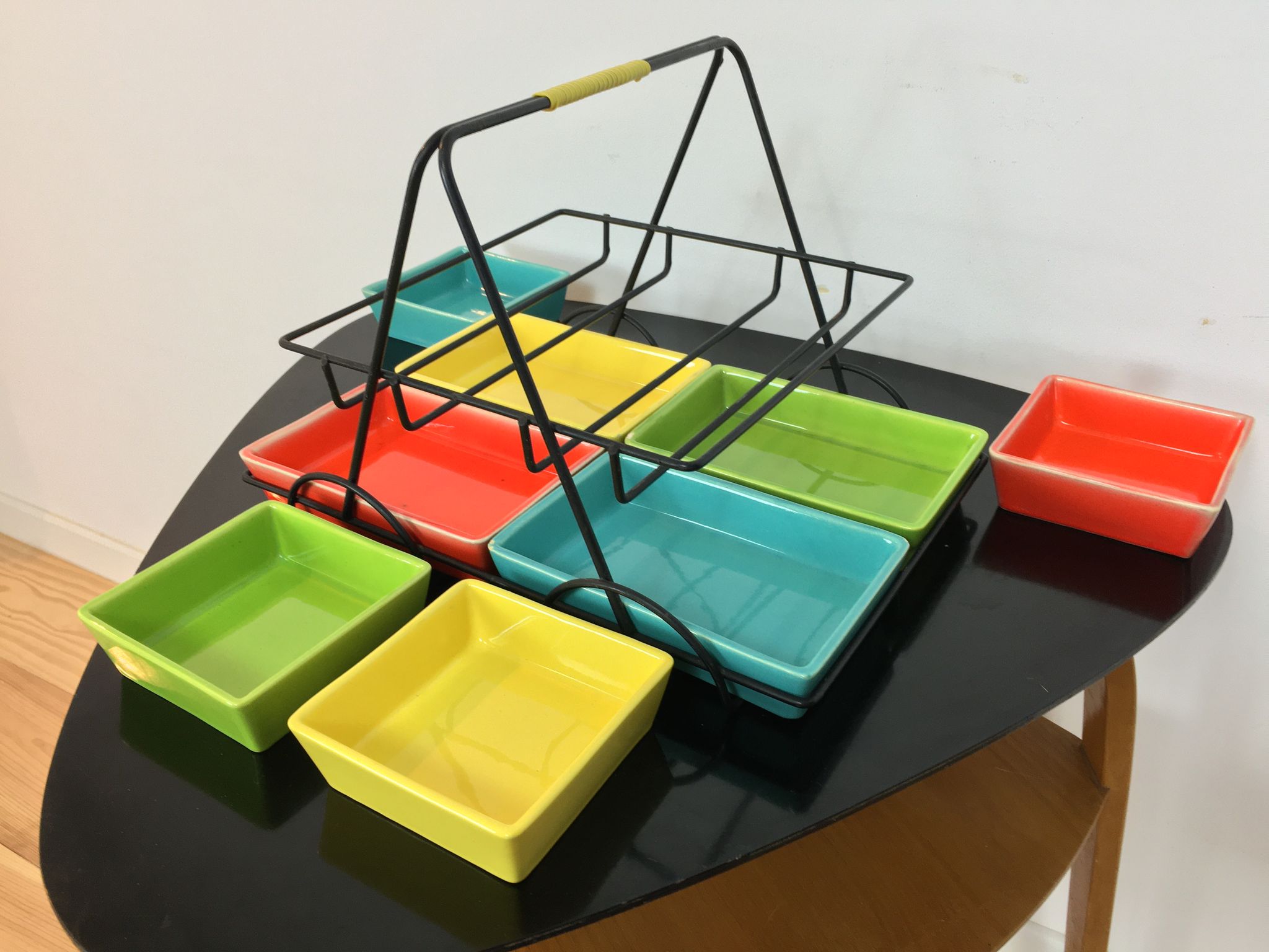 Black metal appetizer set with colorful ceramic ramekins