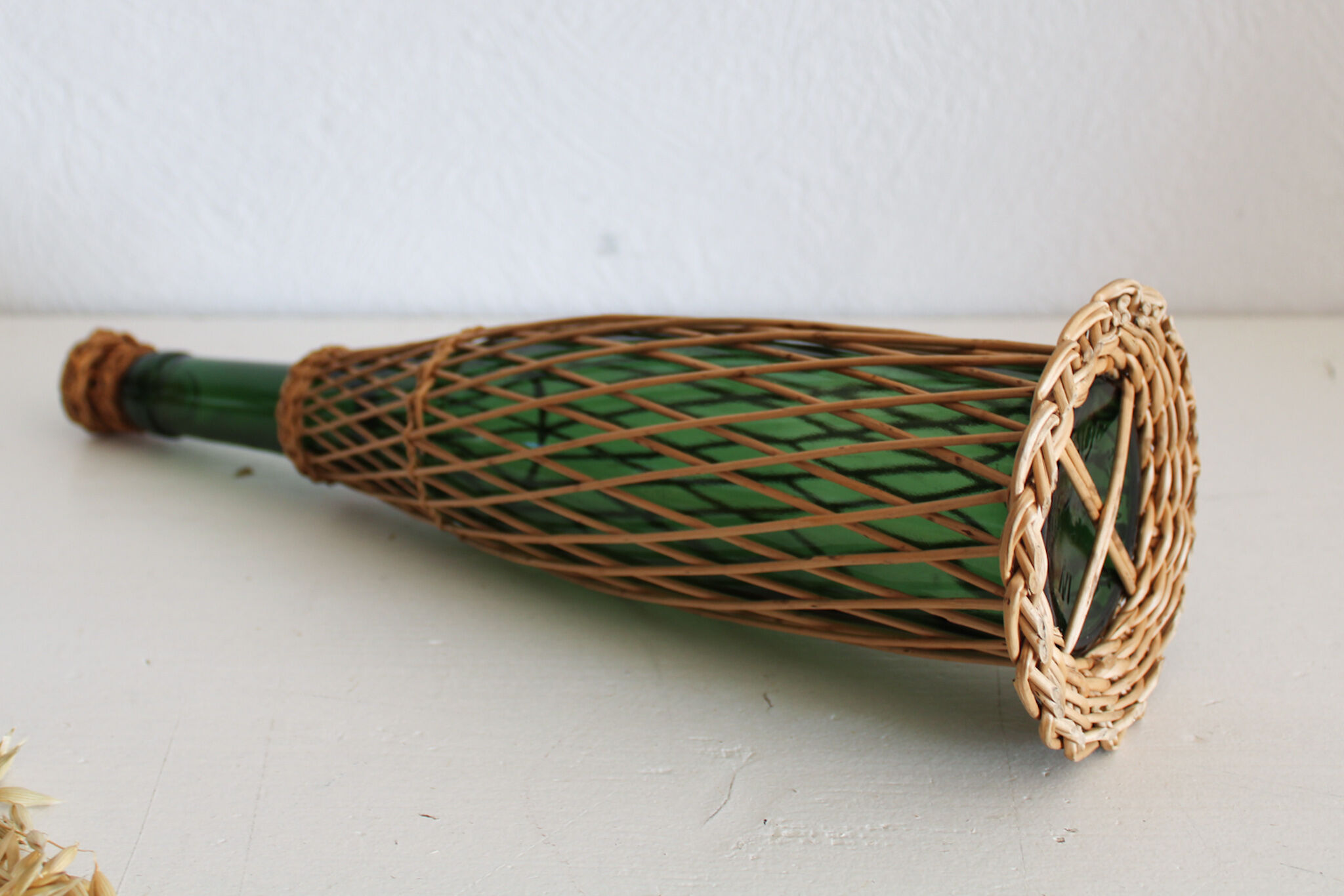 Glass and wicker bottle