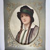 Old portrait of a young woman with braids and a hat, circa 1930