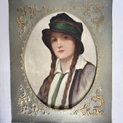 Old portrait of a young woman with braids and a hat, circa 1930