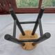 Low wooden stool and black patina