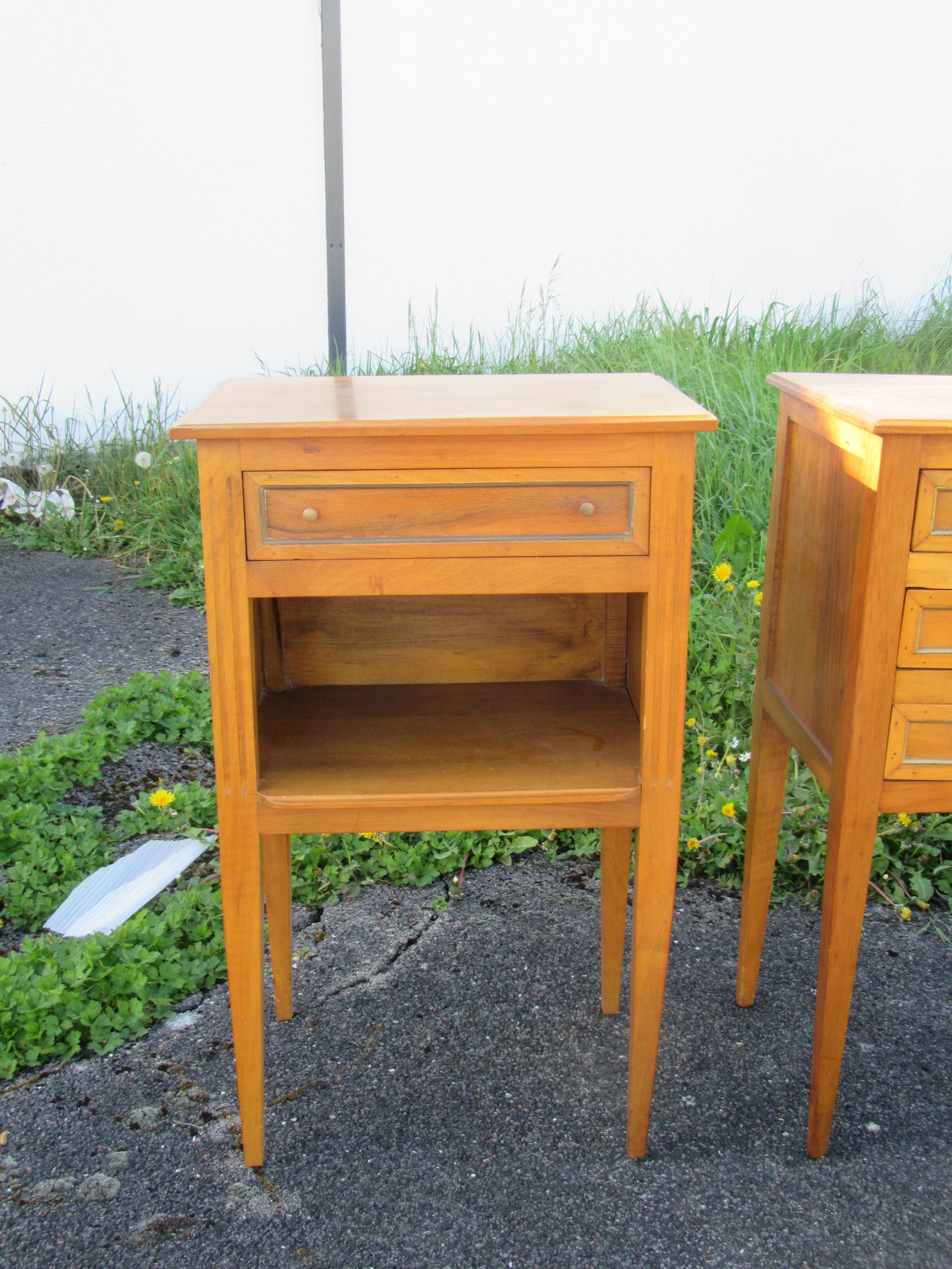 Pair of walnut bedside tables in Louis XVI style with brass inlay.