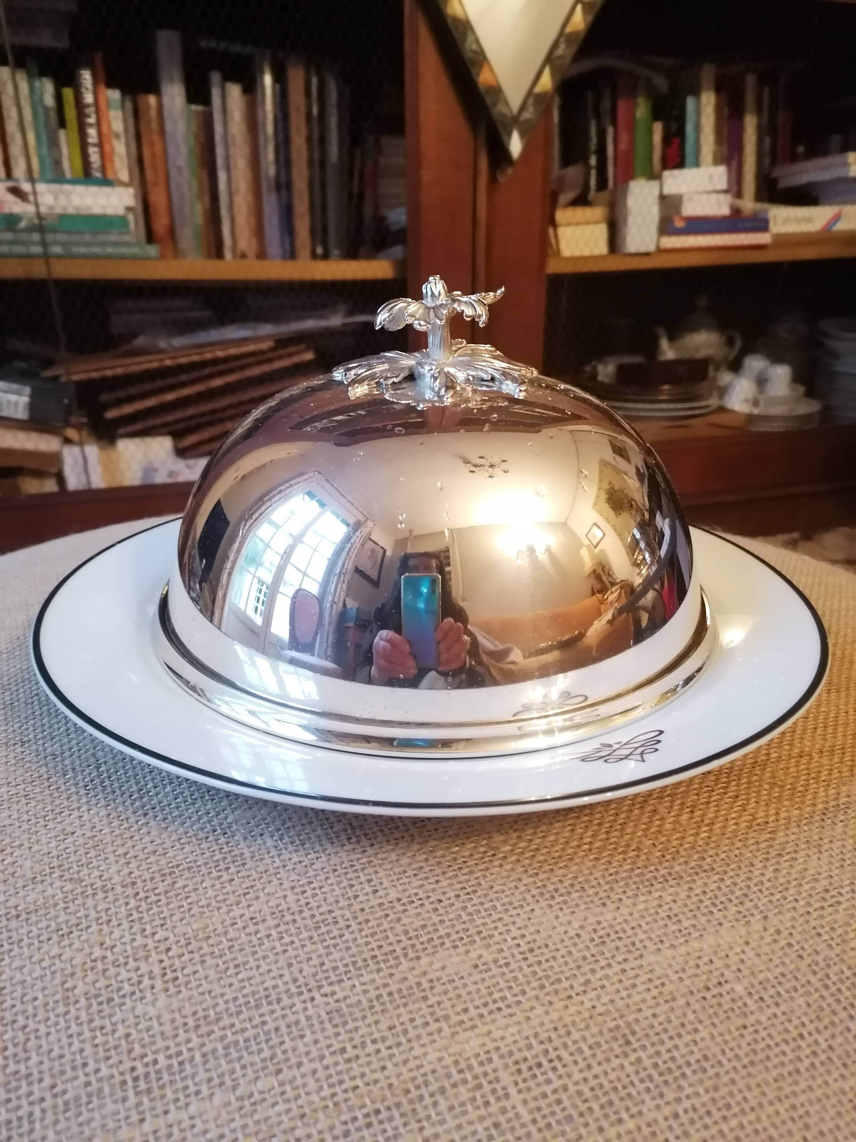 Silver metal bell on its porcelain dish