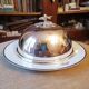 Silver metal bell on its porcelain dish