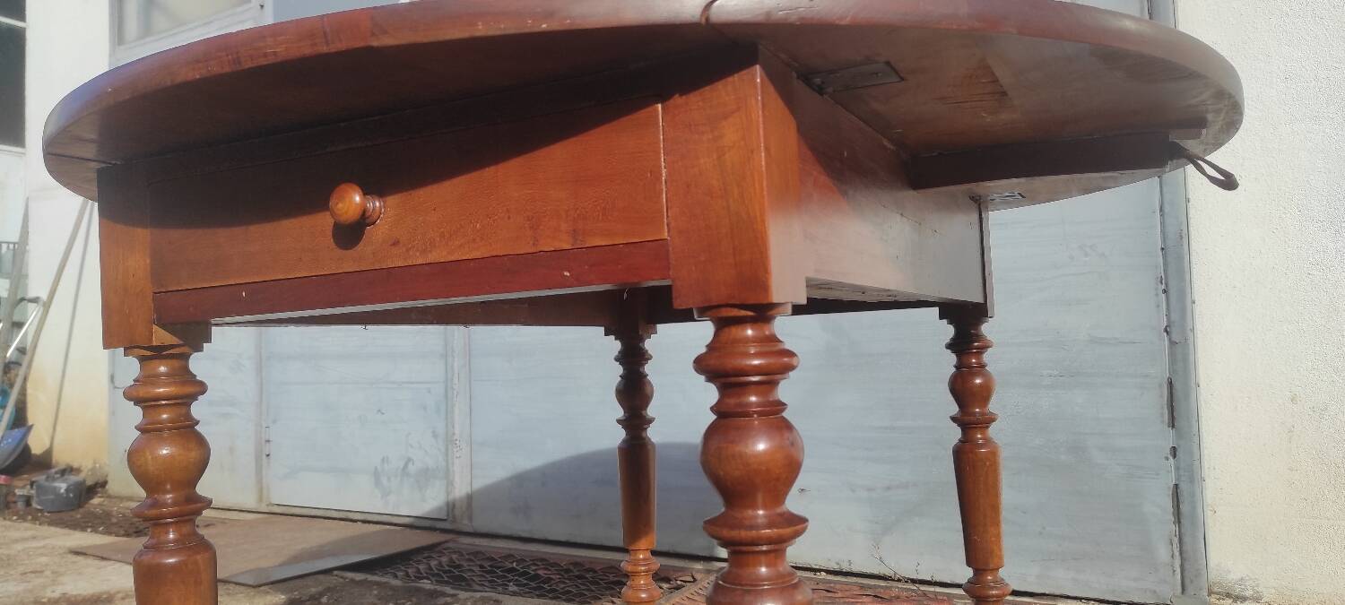 Old extendable round table in fruit wood with folding sides