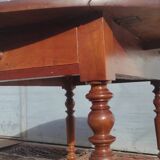 Old extendable round table in fruit wood with folding sides