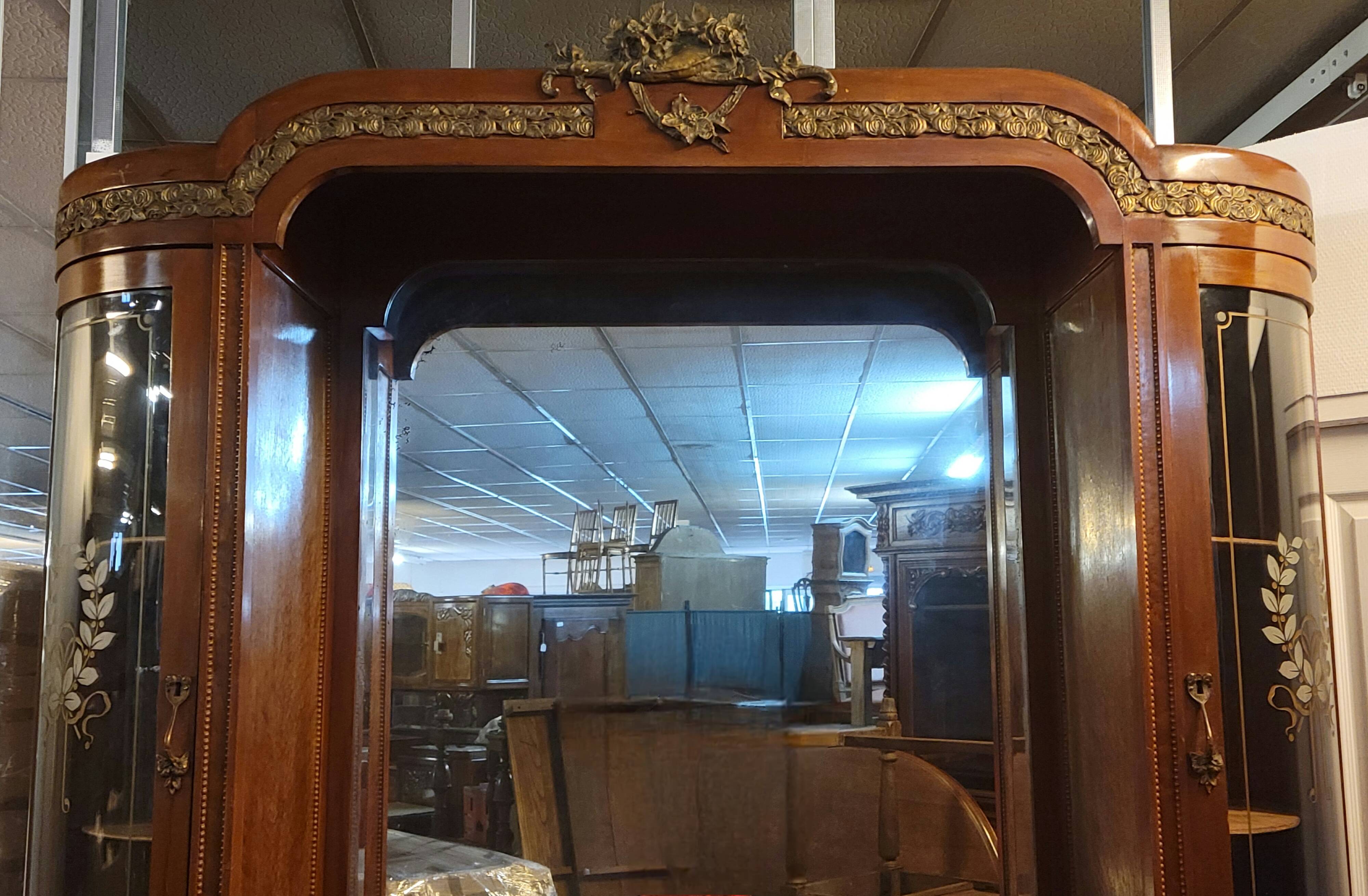 Empire style half-moon shaped mahogany bookcase with putti