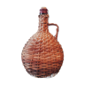 Old rattan carafe wicker bottle