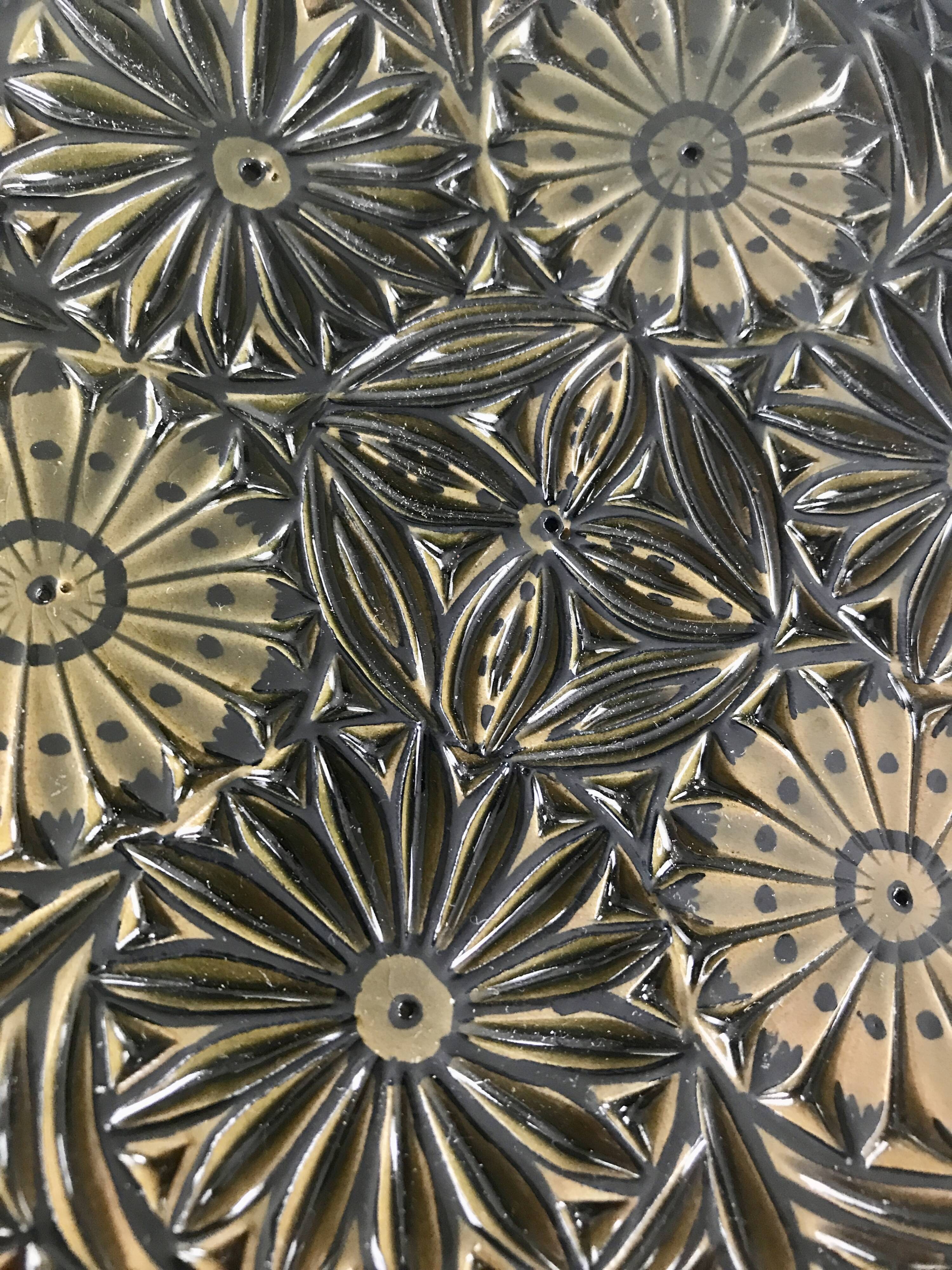 Small decorative chiseled ceramic plate