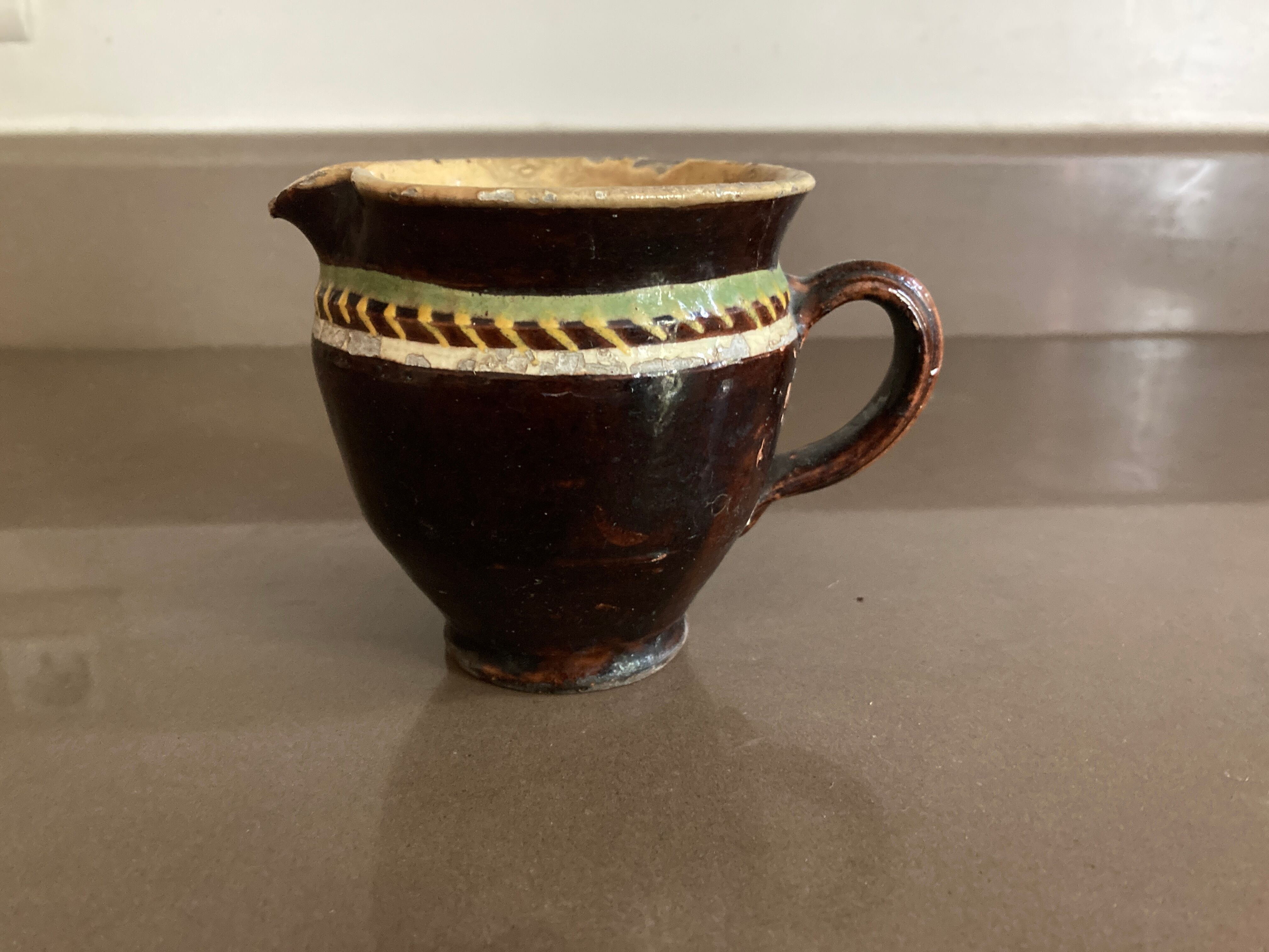 Antique pottery milk jug