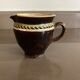 Antique pottery milk jug