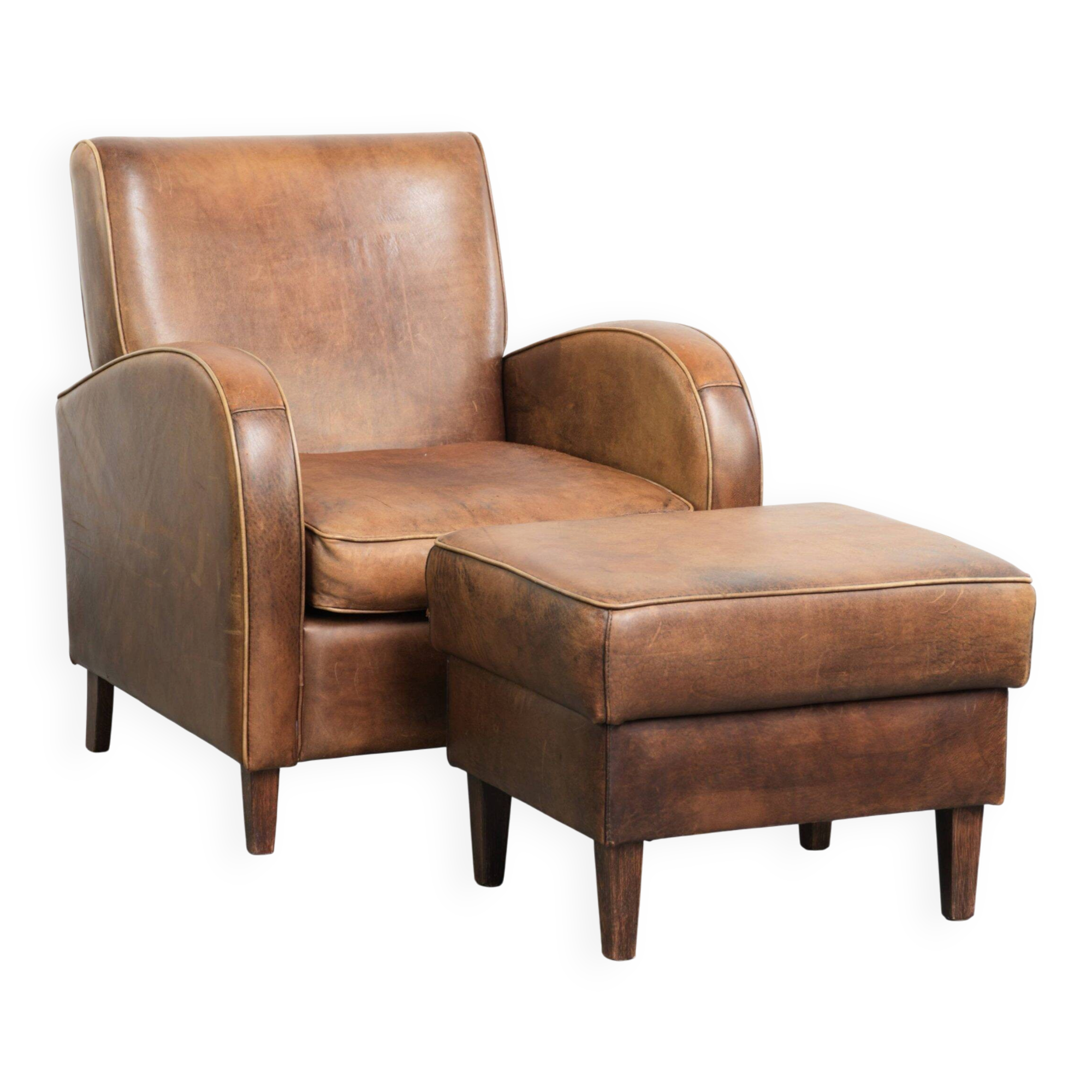 Set of a sheepskin armchair and ottoman finished with matching piping