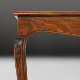 Side table with sculpted elements and rattan top