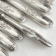 12 antique silver-plated knives with acanthus shell decoration and stainless steel blades.