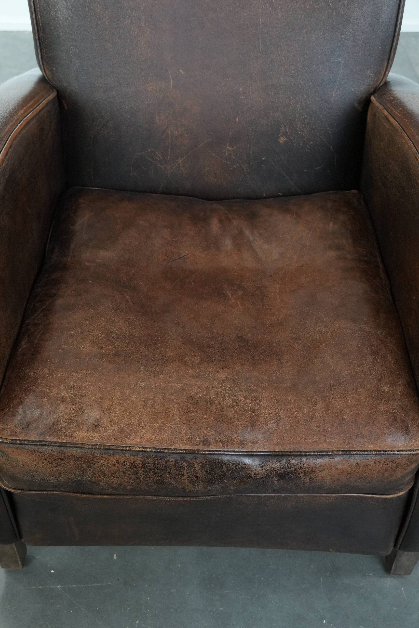 Vintage sheepskin leather design armchair in a dark cognac colour