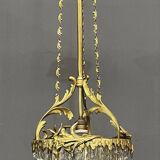 Antique chandelier in gilded bronze with crystal pendants.