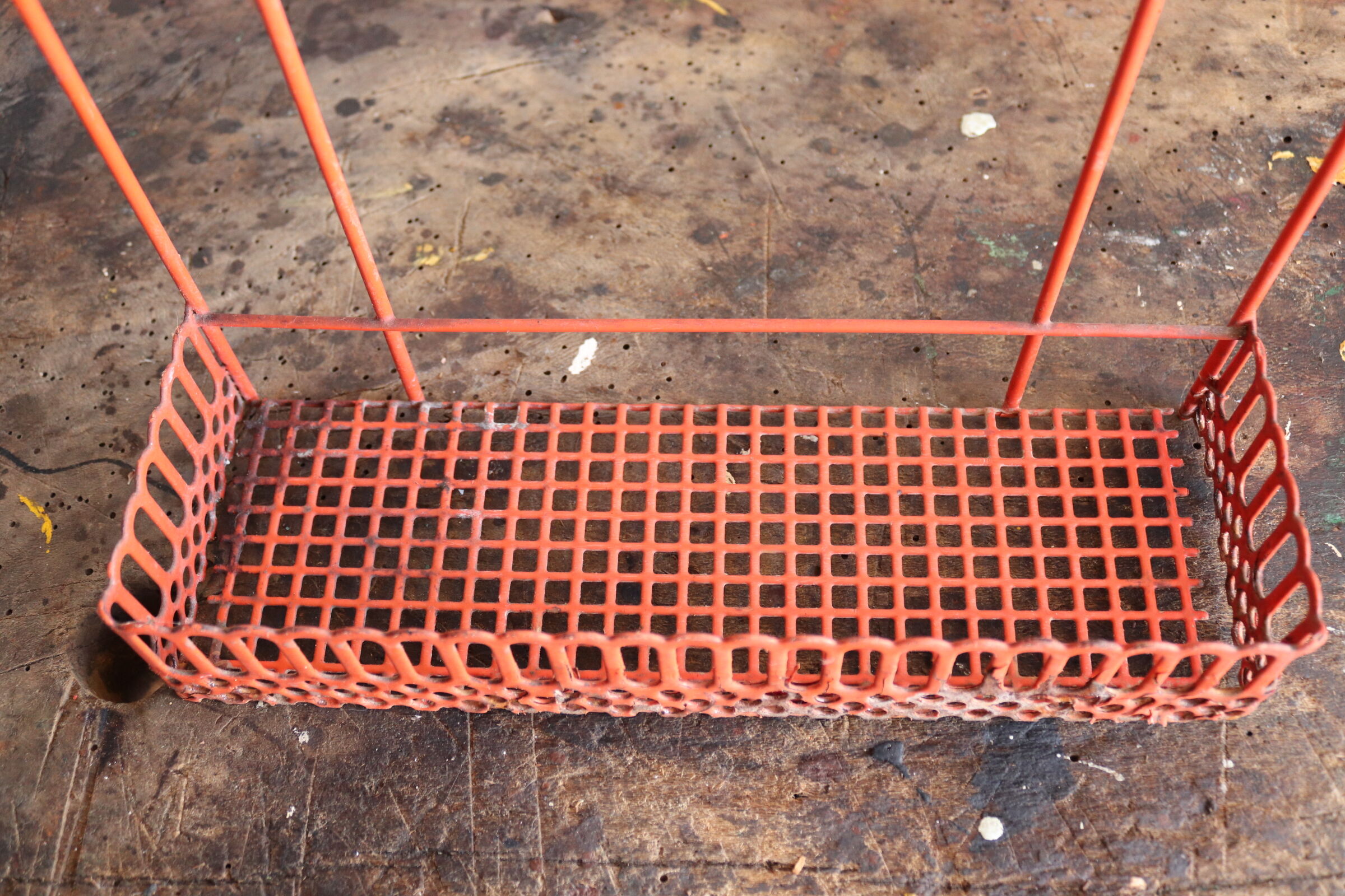 Vintage shelf in red openwork metal