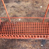Vintage shelf in red openwork metal