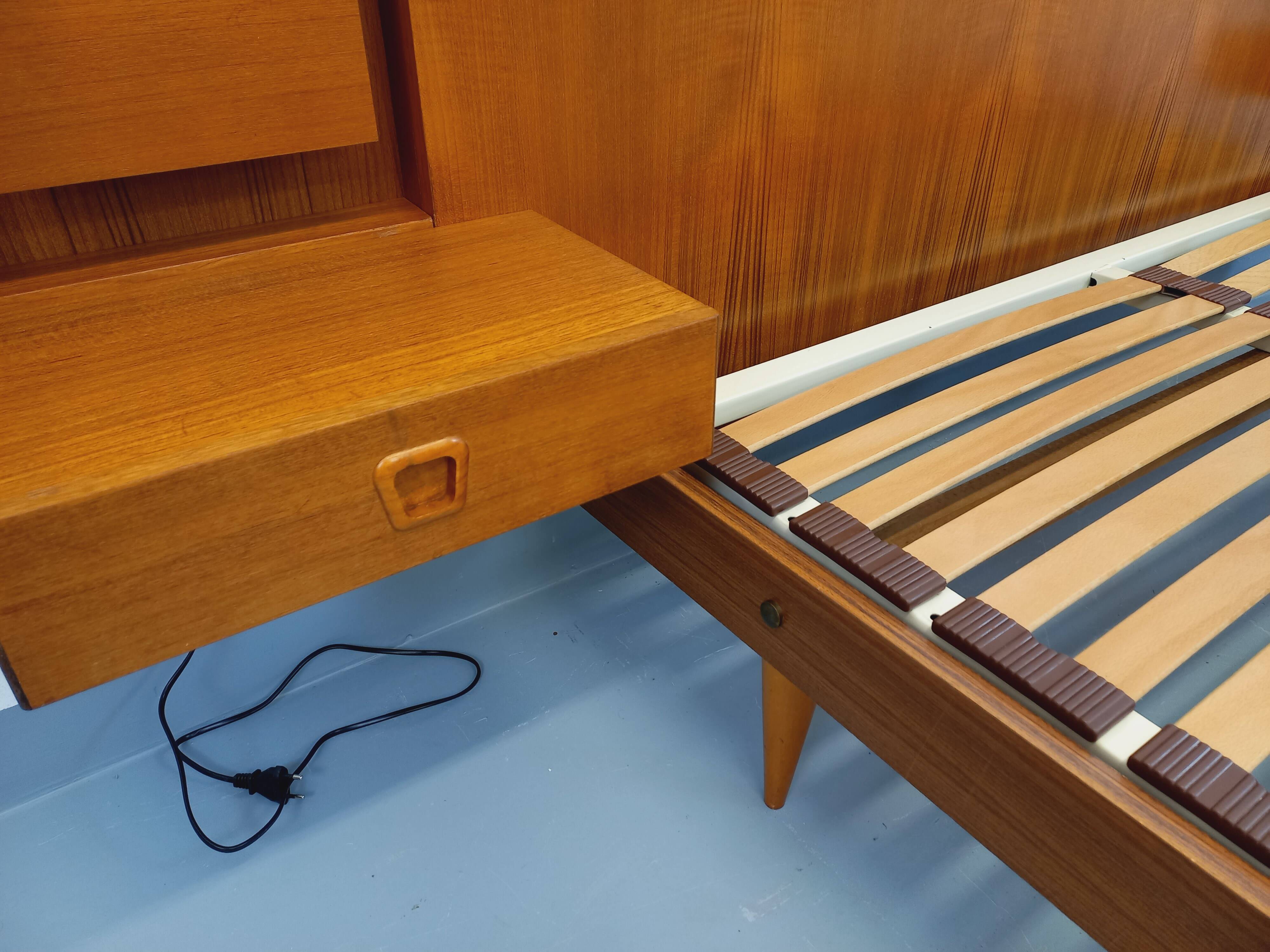 Double bed in vintage Scandinavian style from the 1960s with bedside tables in teak.