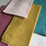Set of four old damask towels tinted in multiple colors