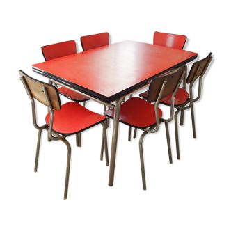 TABLE with two Italian EXTENSIONS and its 6 vintage CHAIRS of the 1970s in red color