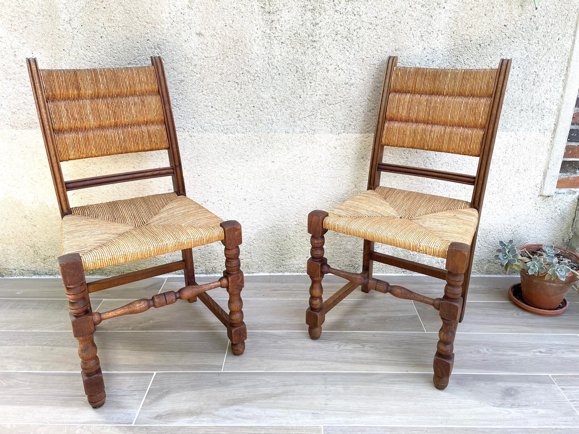 Pair of straw and solid oak chairs