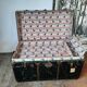 Old and large travel trunk, brass-plated corners