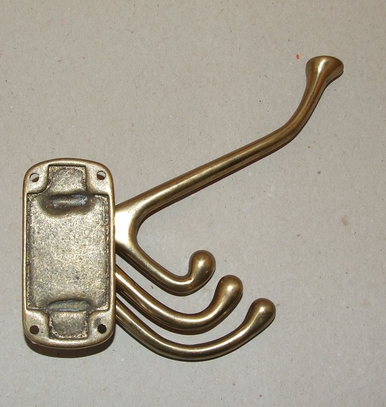Articulated brass patère