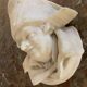 Marble sculpture, man's head in a hat.